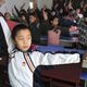 Pupils practice a set of martial arts "smog preventing" exercises in a classroom at a primary school in Shijiazhuang, Hebei province December 11, 2013. The school invented the set of exercises, which consists of 23 different martial arts moves, claiming it can improve physical conditions of the students and reduce the harm of smog. Air quality in cities is of increasing concern to China's stability-obsessed leaders, anxious to douse potential unrest as a more affluent urban population turns against a growth-at-all-costs economic model that has poisoned much of the country's air, water and soil. Picture taken December 11, 2013. REUTERS/Stringer